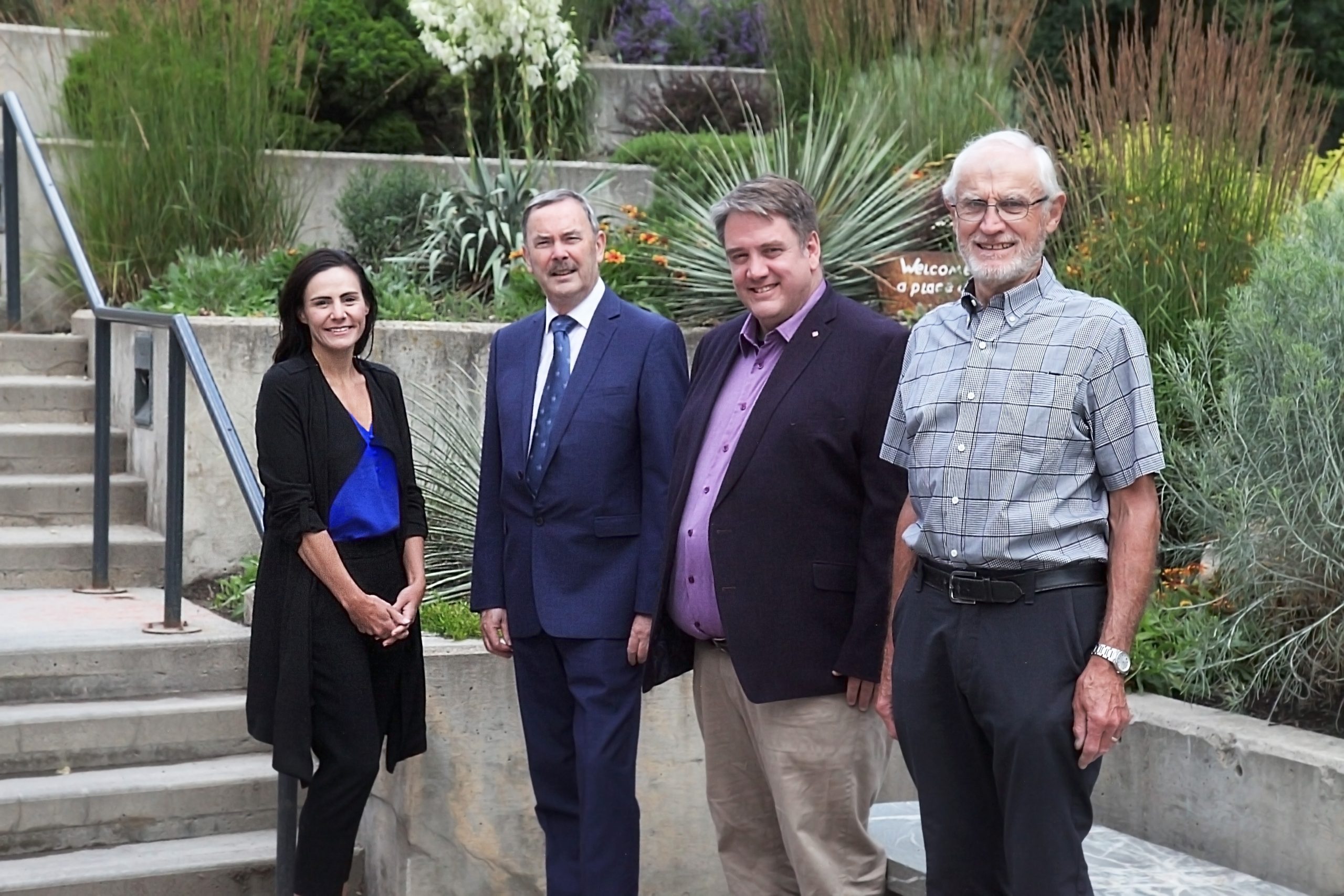 Delegation from the Irish Consulate in Vancouver with representatives from the UBC Okanagan International Office in front of staircase on UBC Okanagan campus.